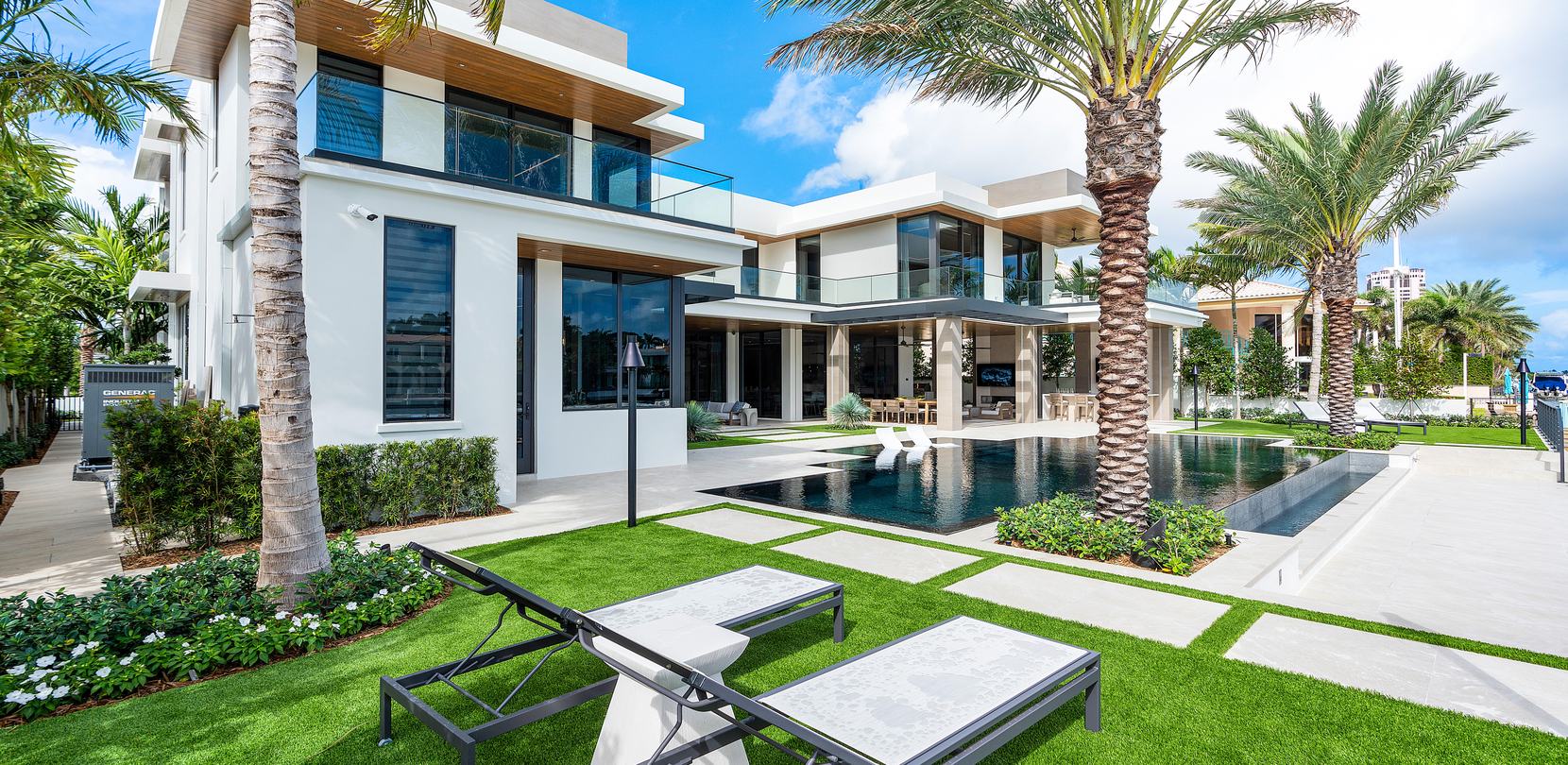 Modern home with a pool, turf lawn and stepping pavers