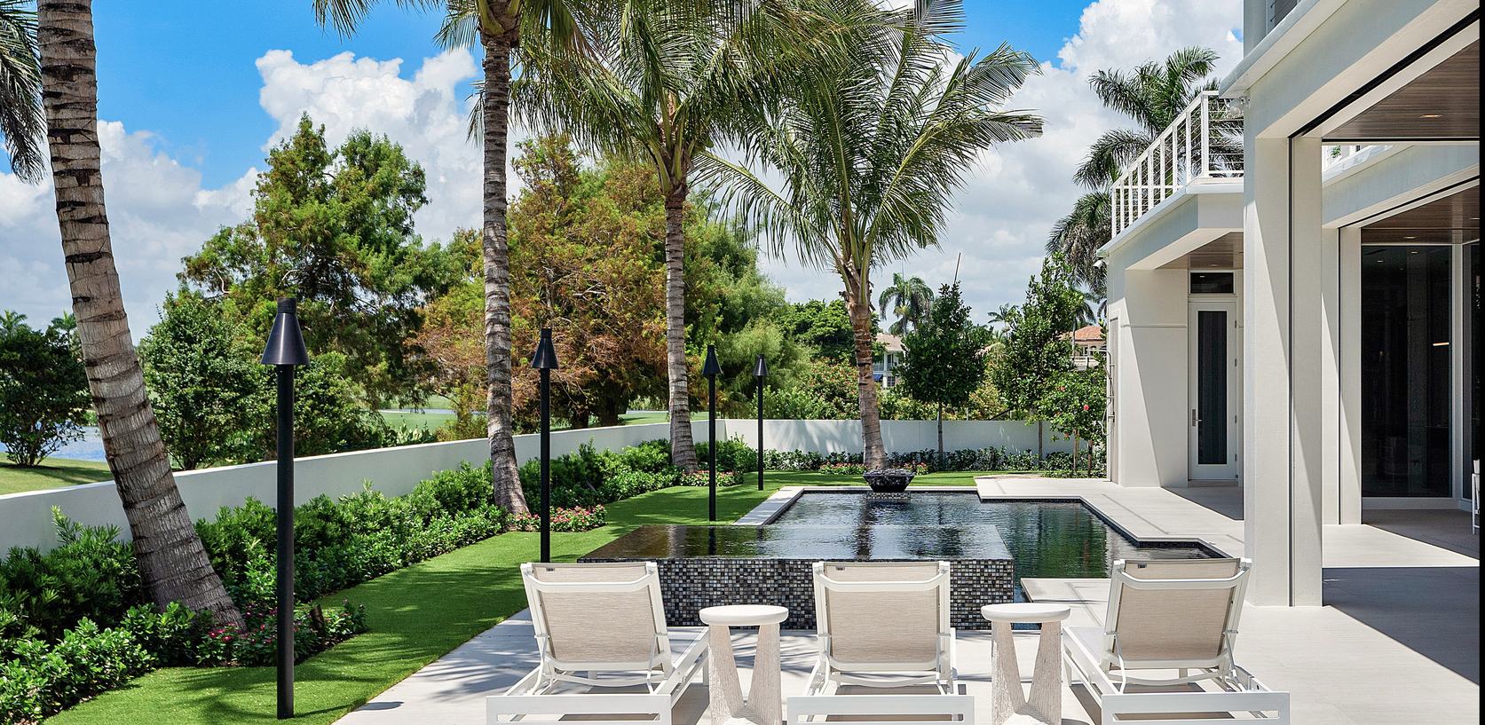 Poolside terrace with palms and lounge chairs